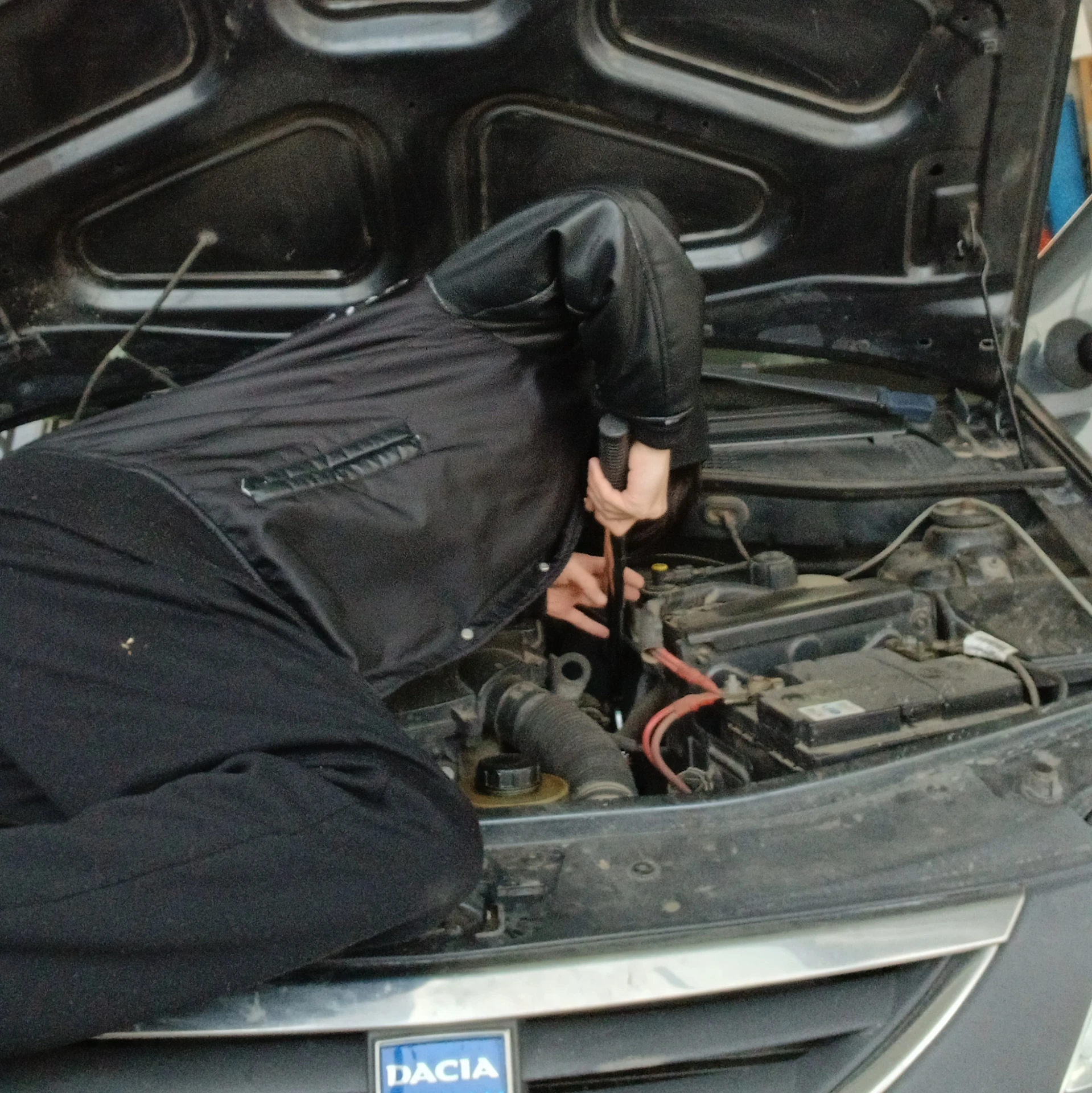 Hands-on mechanical work on a car engine bay